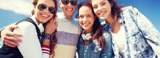 summer holidays and teenage concept - group of teenagers outside