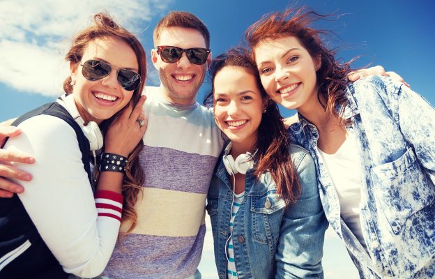summer holidays and teenage concept - group of teenagers outside